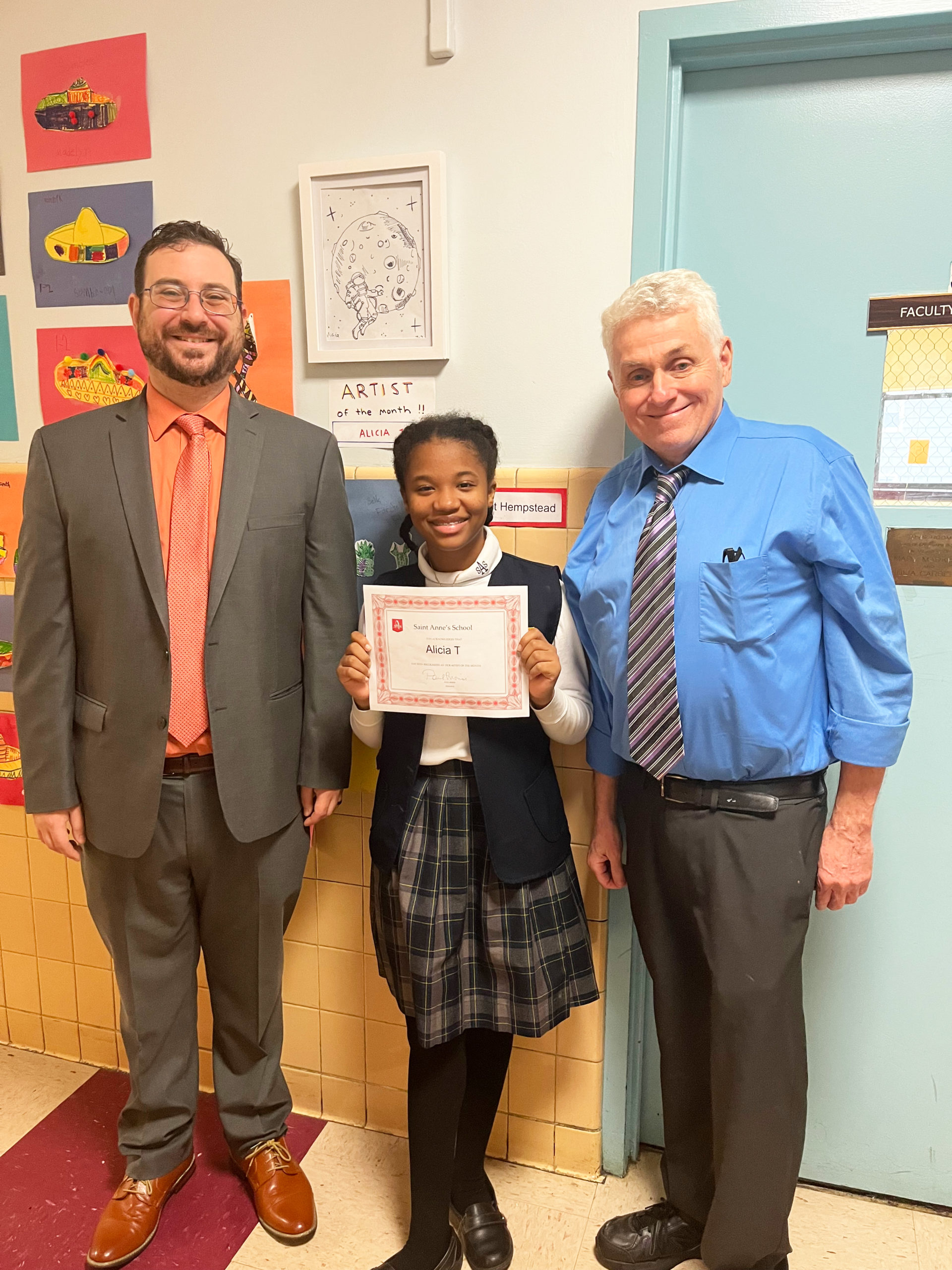 Principal Paul Morisi (left) with Alicia T. (center) and Art teacher Mr. Carrol (right). Notice her art framed on the wall!